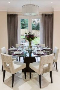 contemporary dining room with double doors half covered with curtains