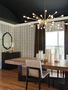 black ceiling in modern dining room with gold lighting and geometric wallpaper
