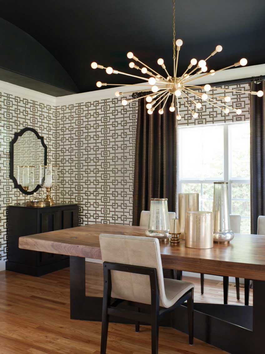 black ceiling in modern dining room with gold lighting and geometric wallpaper