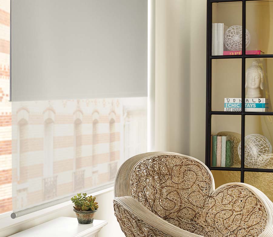 dual roller shades with round bottom bar in the corner of an apartment