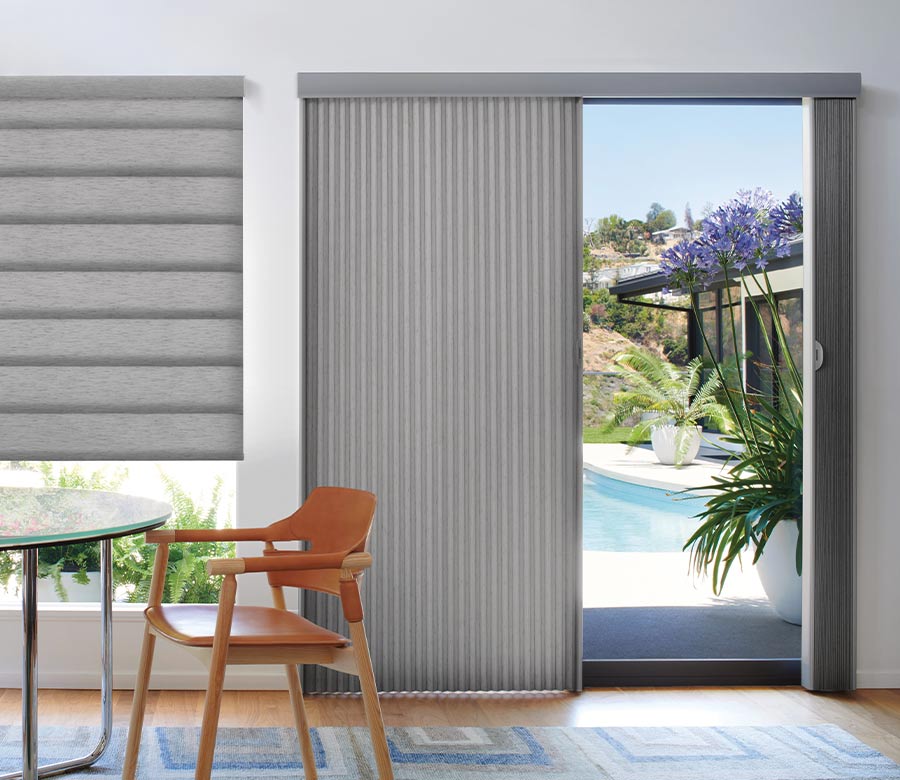 glass patio door leading to pool area covered by a vertical cellular shade in gray fabric