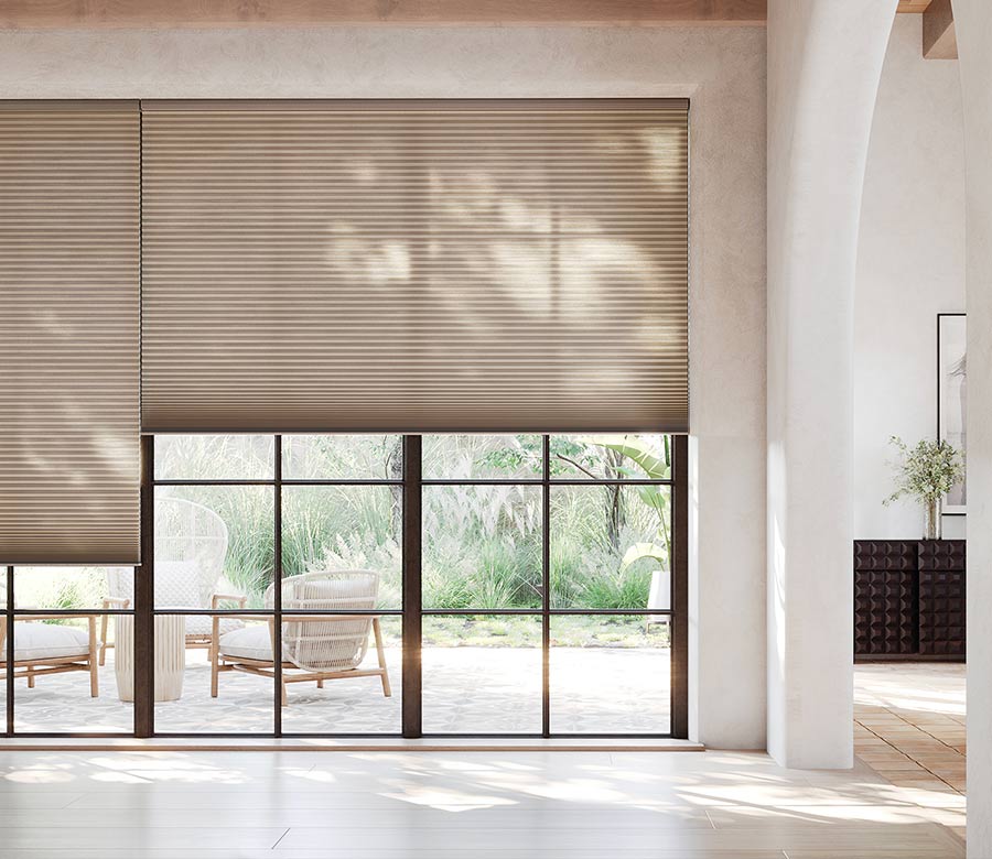large glass windows facing outdoor space with brown honeycomb shades