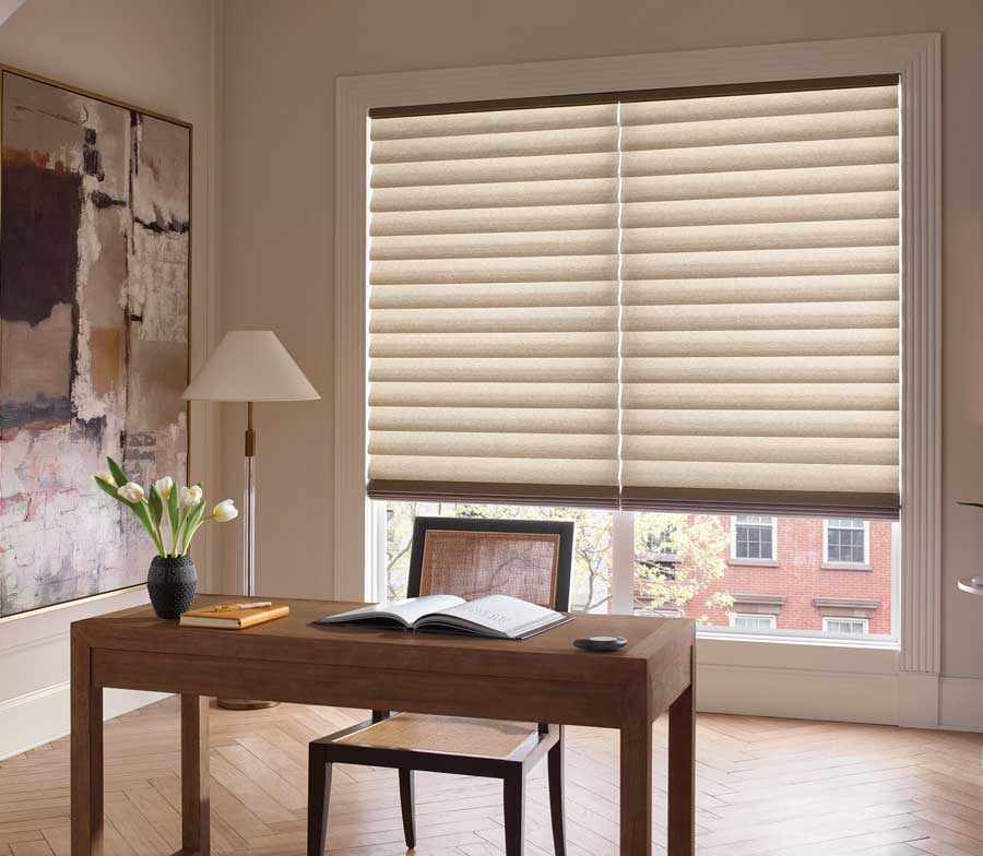 roman shades on large window behind desk in office nook