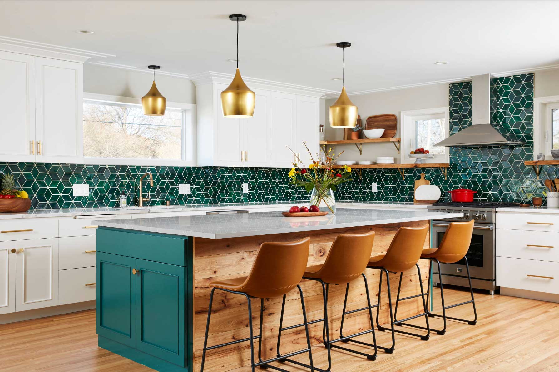 blue and white kitchen with gold fixtures and brown chairs