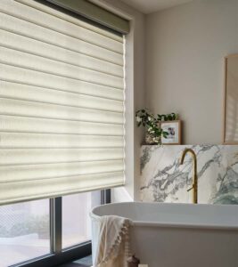 bathroom with white pirouette shades and white soaking tub
