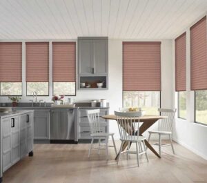 Sonnette Cellular Shades covering three-fourths of the windows in an open concept kitchen and dining room
