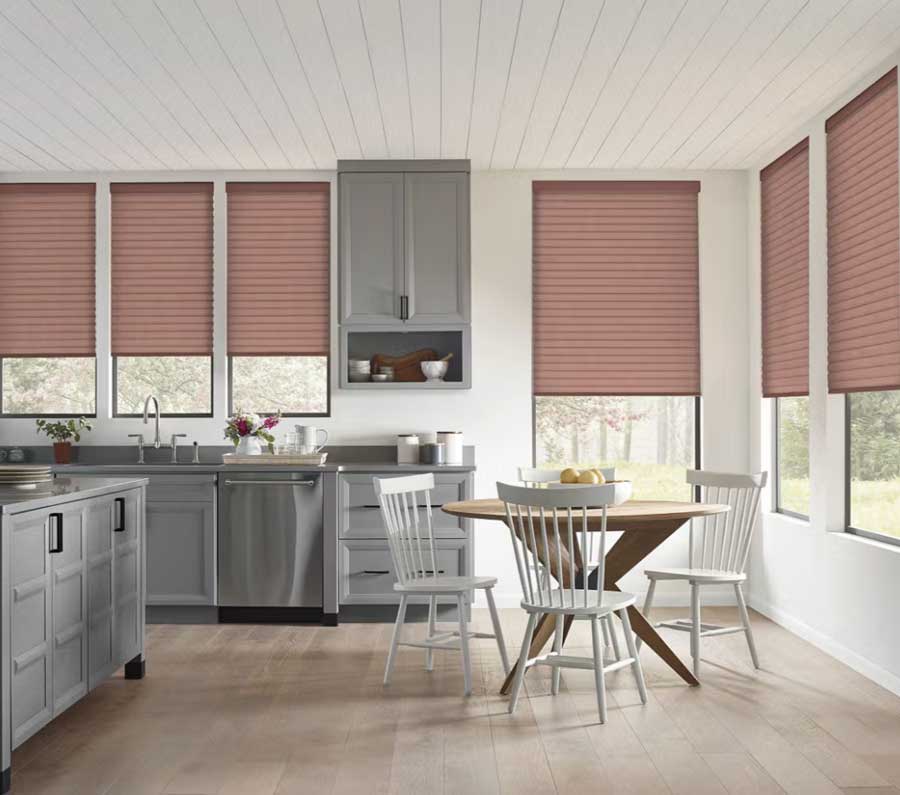 Sonnette Cellular Shades covering three-fourths of the windows in an open concept kitchen and dining room