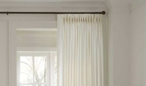 Triple Pleat, Pinch Pleat Drapery on a white wall and in a neutral light tone