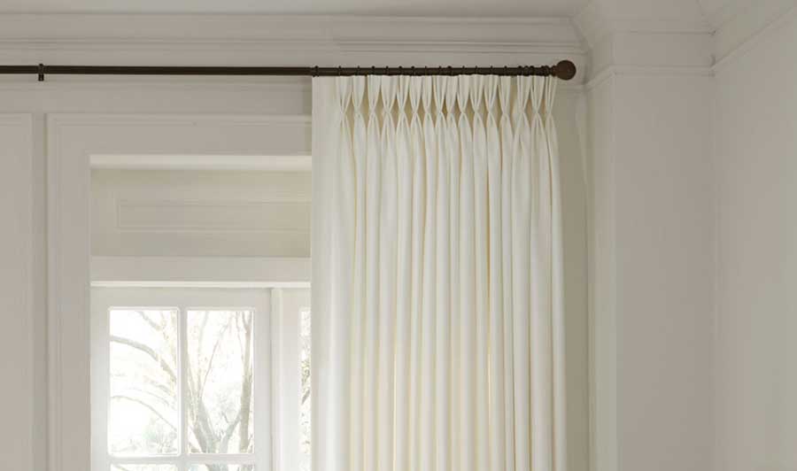 Triple Pleat, Pinch Pleat Drapery on a white wall and in a neutral light tone