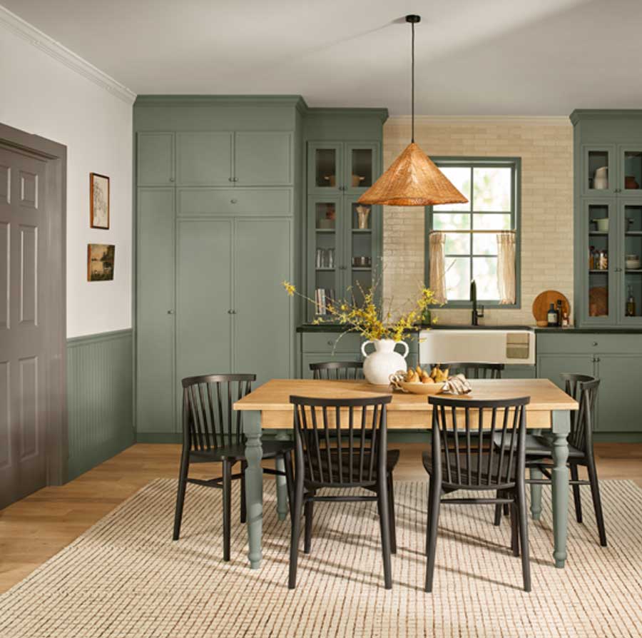 Soft green built in cupboards in a kitchen