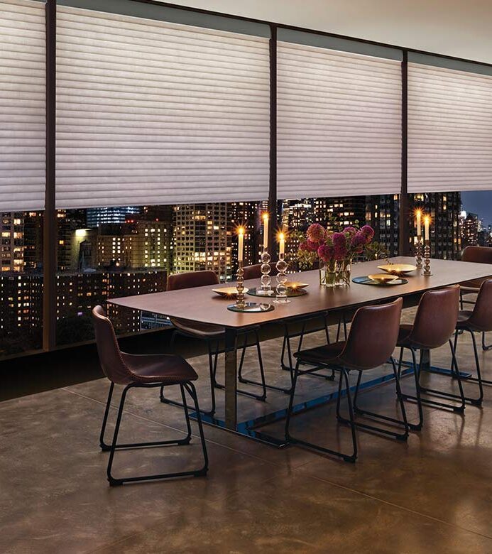 aura-illuminated-shades-cellular-duette-honeycomb-shades-hunter-douglas-bazaar-home-decorating exterior wall of windows with LED strip lighting on window shades for increased interior light