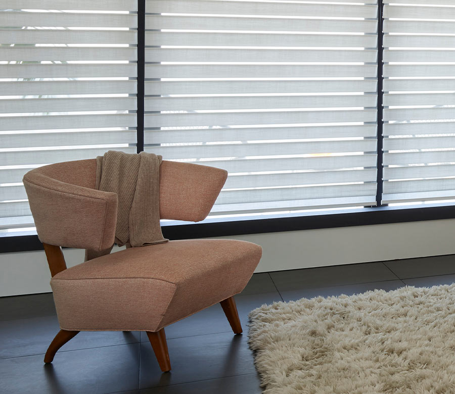 Silhouette® sheer window treatments gently filtering daylight through layered fabric vanes for soft light control