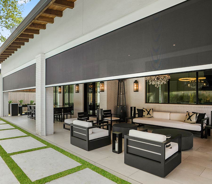 Outdoor patio shades lowering to block glare while preserving the backyard view