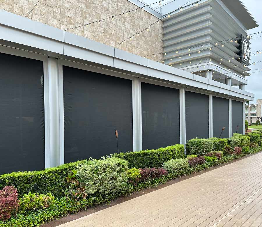 Motorized patio screen shades creating a comfortable outdoor living space