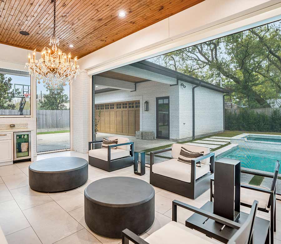 Exterior roller shades installed on a covered patio for shade, privacy, and UV protection