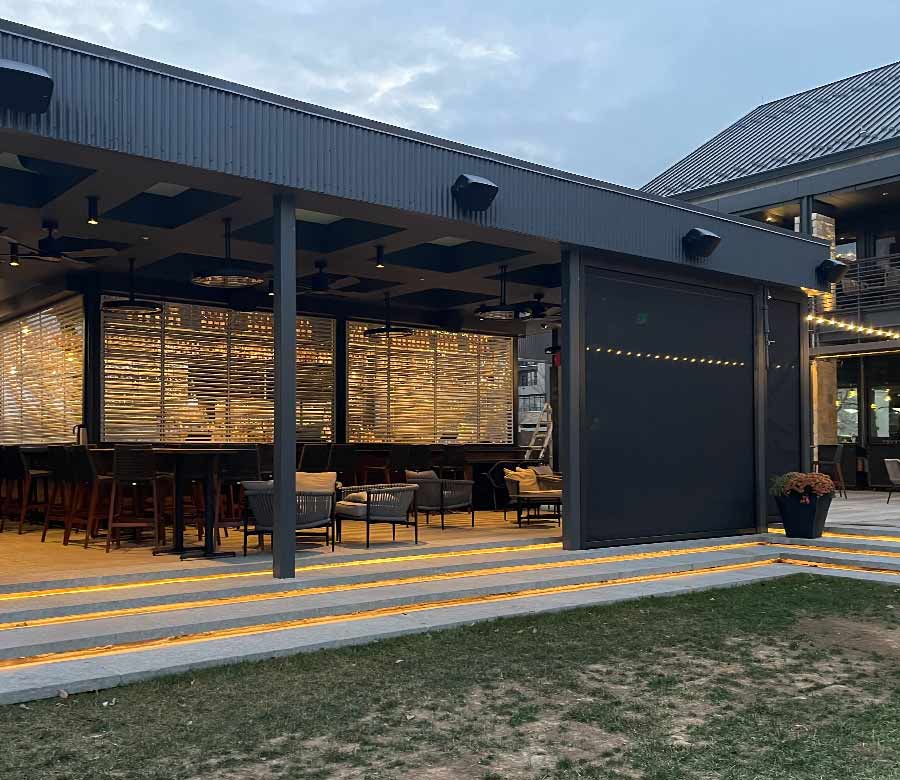 Motorized exterior screen shades on a covered deck